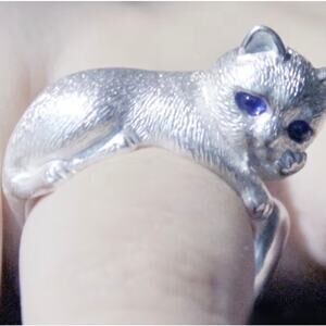 Charming Zinc Alloy cat ring, paw-to-cheek pose, blue crystal eyes.